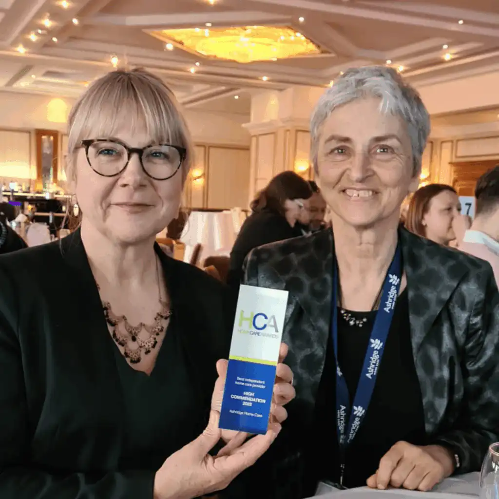 Trudi, Owner and Director of Ashridge Home Care holding a Home Care Award at the 2022 ceremony, alongside a professional carer.