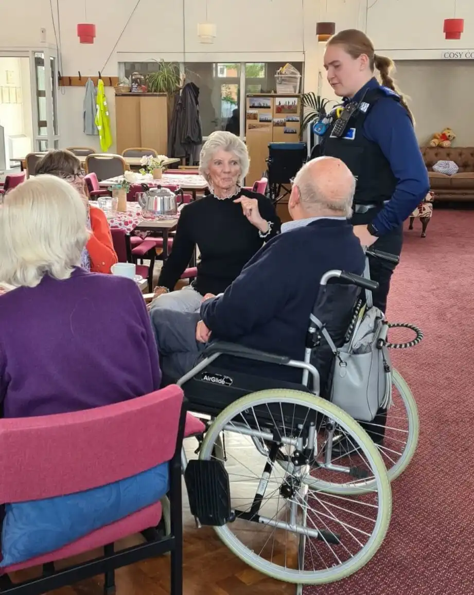 Group of four people and a local community police support officer enjoying refreshments as part of Silver Sunday even in Buckinghamshire.