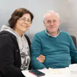 Ashridge Home Carer with client visiting the office and enjoying tea and cake.