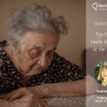 An elderly woman with grey hair looks down thoughtfully, seated at a table. Overlay text: "Guest blog: Together to tackle loneliness in the elderly."