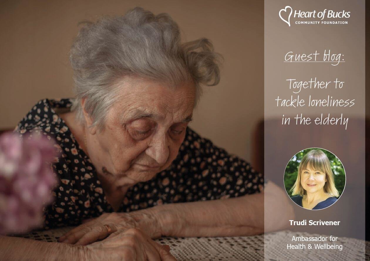 An elderly woman with grey hair looks down thoughtfully, seated at a table. Overlay text: "Guest blog: Together to tackle loneliness in the elderly."