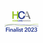 Logo for Home Care Awards 2023 with bold green and grey "HCA" letters above "Finalist 2023" in blue. Wavy green and blue lines decorate the design.