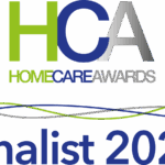 HCA Home Care Awards logo in green, blue, and grey on a black background with 'Finalist 2024' in bold blue below, featuring wavy colour lines.