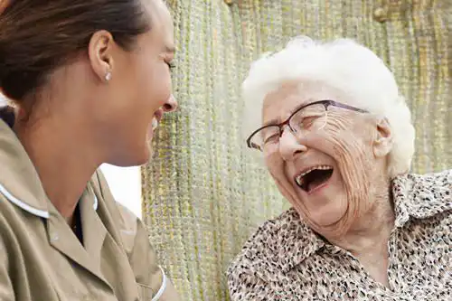 Elderly client laughing and enjoying an outing with their professional carer.