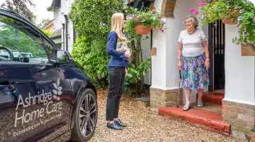 Client services manager Agata greeting a new client to discuss setting up their tailored care service.