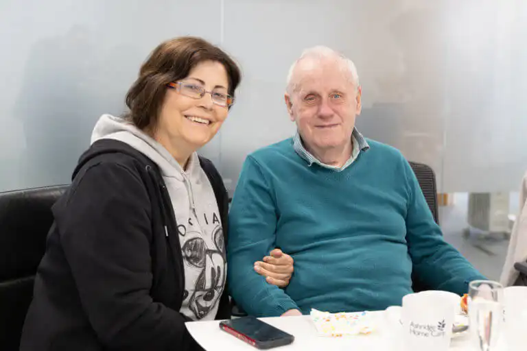 Ashridge Home Carer with client visiting the office and enjoying tea and cake.