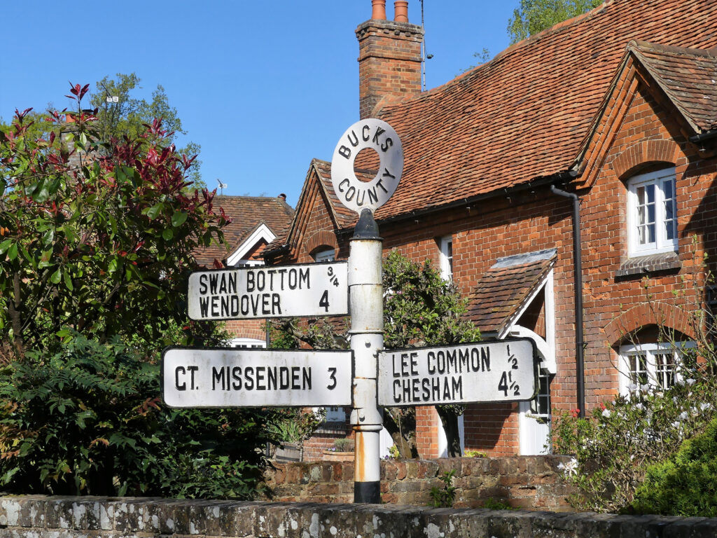 Bucks County road sign at The Lee, Buckinghamshire, England, UK with distances to Swan Bottom, Wendover, Great Missenden, Lee Common and Chesham