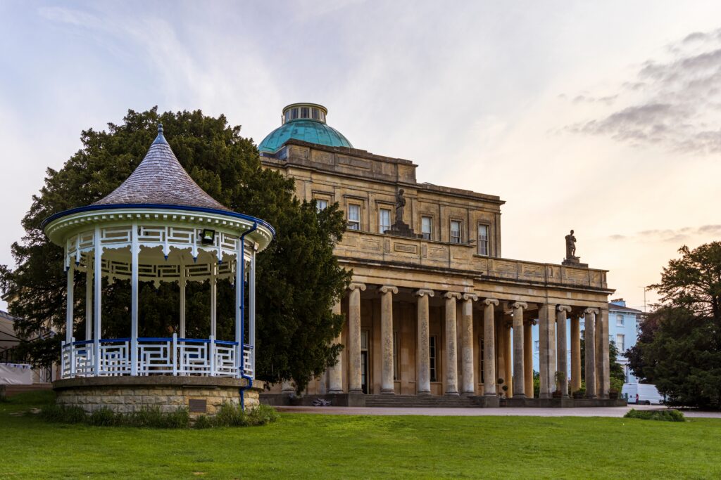 Pittville Pump Room and old spa mineral water buildings in Pittville Park, Cheltenham, Gloucestershire, England