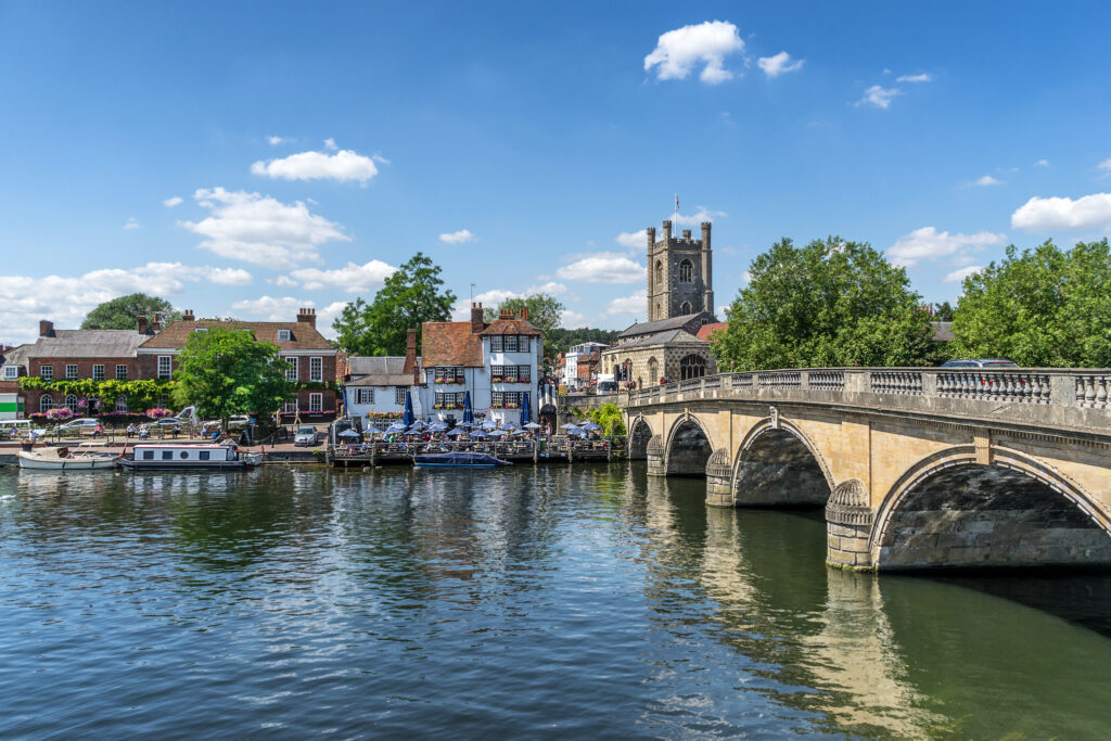 View across the river Thames, showing restaurants and buildings on the river bank at Henley on Thames in Oxfordshire