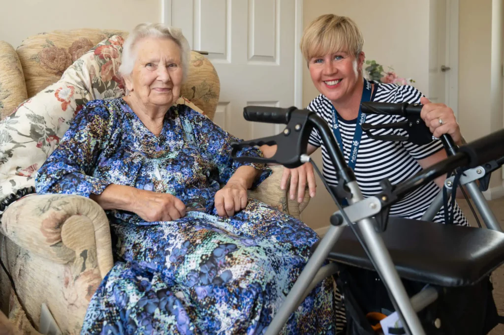 Elderly lady in armchair with her live-in carer