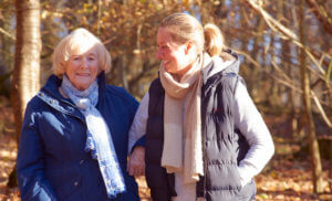 After stroke care-old lady and carer on a walk