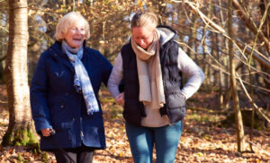 Care plan-old lady and carer on a walk