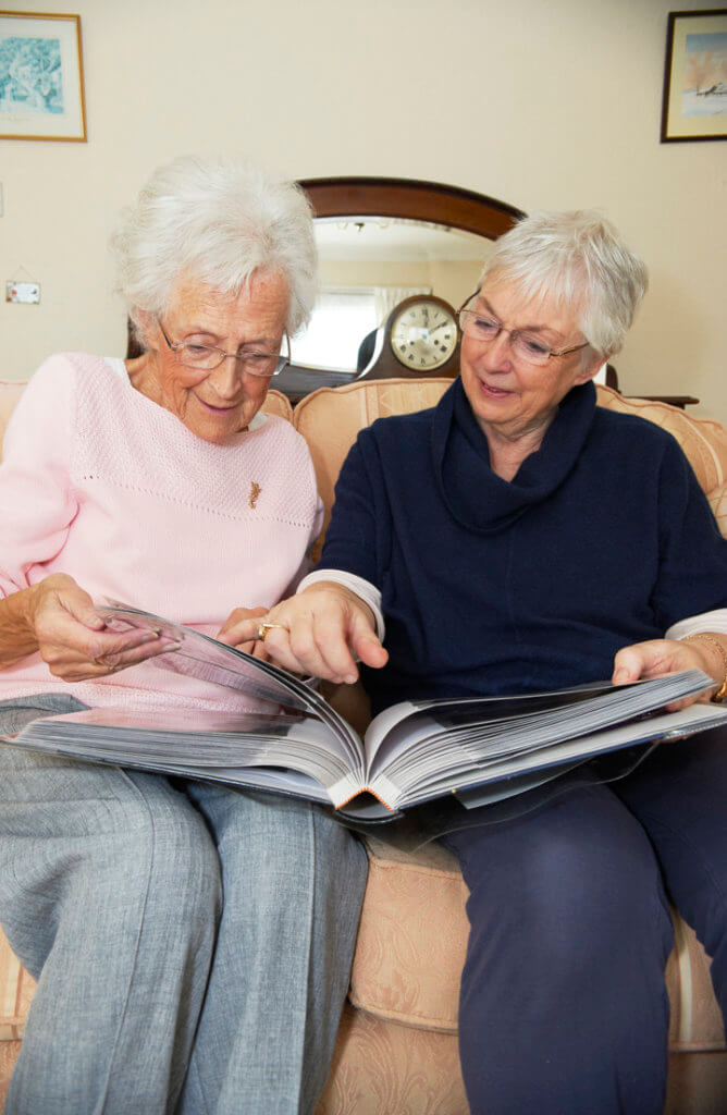 Companion care-elderly ladies browsing pictures